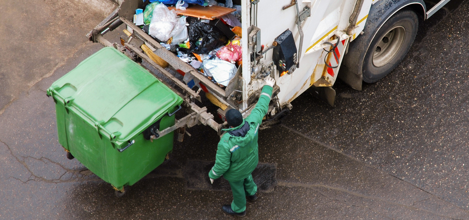 Man emptying rear loading truck