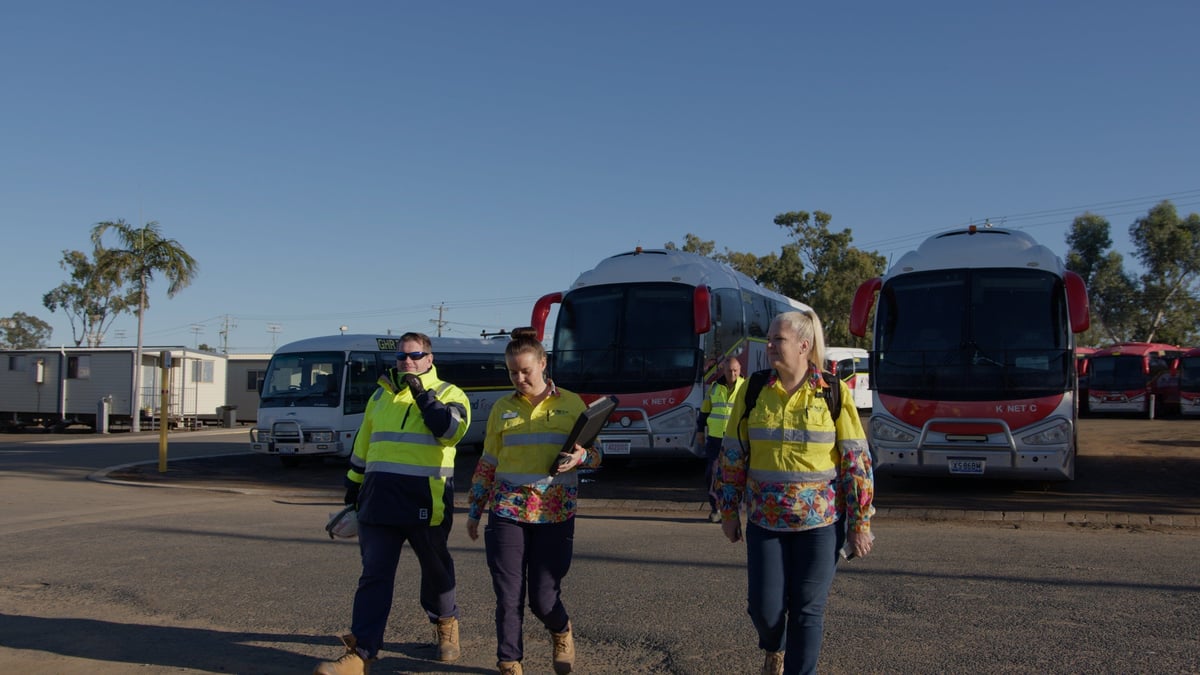 Kinetic team in front of the vehicles